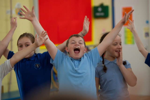 PPA Cover in Primary School - child raising their hands in joy